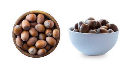Hazelnuts isolated on white background. Hazelnuts in a bowl with copy space for text. Hazelnut close-up. Top view.
