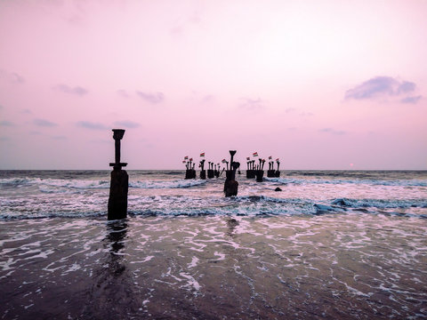 evening view beach calicut with broken sea bridge pillars wallpaper