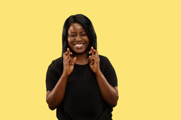 Young african-american woman isolated on yellow studio background, facial expression. Beautiful...
