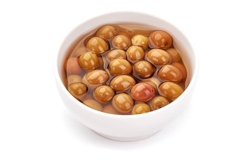 Pickled Arbequina Olives, close-up, isolated on white background