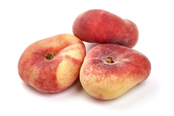 Flat Peaches, ripe nectarines, close-up, isolated on white background