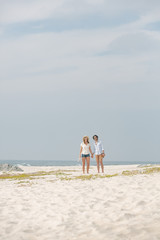 Caucasian couple standing at beach on a sunny day 