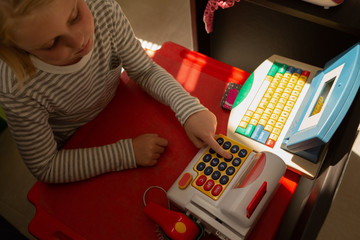 Schoolgirl pretending to be an executive at bill counter
