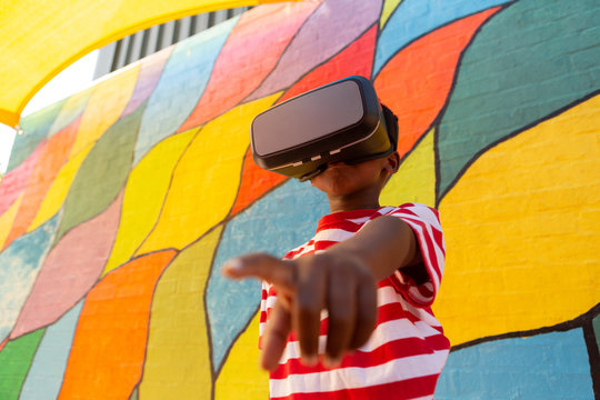 Schoolboy using virtual reality headset in the school playground
