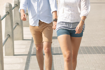 Obraz na płótnie Canvas Caucasian couple walking on the promenade at the seaside