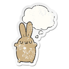 cartoon rabbit and thought bubble as a distressed worn sticker
