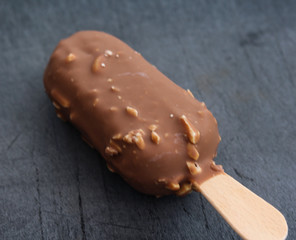 Vanilla milk chocolate almond bar ice cream on black background