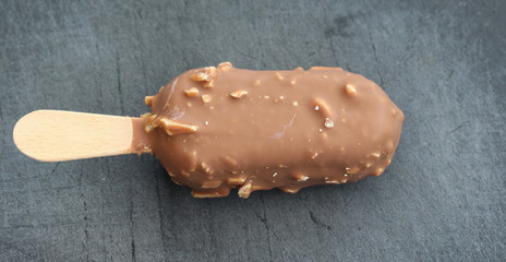 Vanilla milk chocolate almond bar ice cream on black background