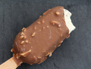 Vanilla milk chocolate almond bar ice cream on black background