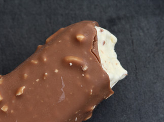 Vanilla milk chocolate almond bar ice cream on black background