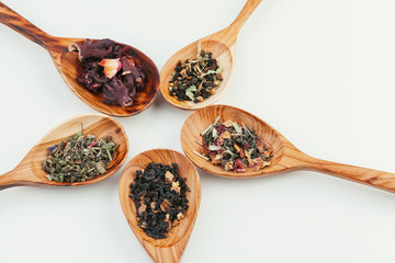 leaf  tea in a wooden spoon isolated on white background