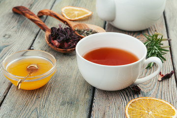 Cup of tea and tea leaves on wooden table