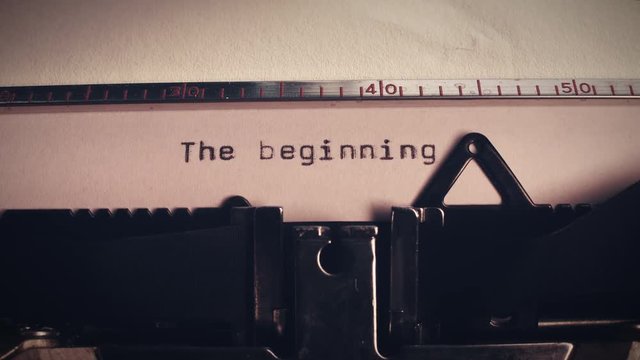 the wiord 'the beginning' being typed on an old vintage typewriter