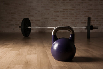 Obraz na płótnie Canvas kettle bell and weight lifting bar on a wooden floor gym.
