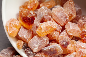 brown sugar rock organic crystalline close up on dark background