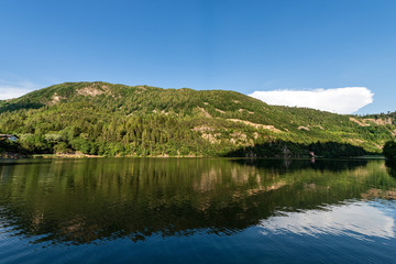Fototapeta na wymiar The beautiful and small Lona Lases lake with reflections and Italian Alps. Trento province, Trentino Alto Adige, Italy, Europe