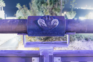 Sign of the zodiac Virgo on the bridge of the Wishing Bridge in the violet light of a spotlight located on old city Yafo in Tel Aviv-Yafo in Israel