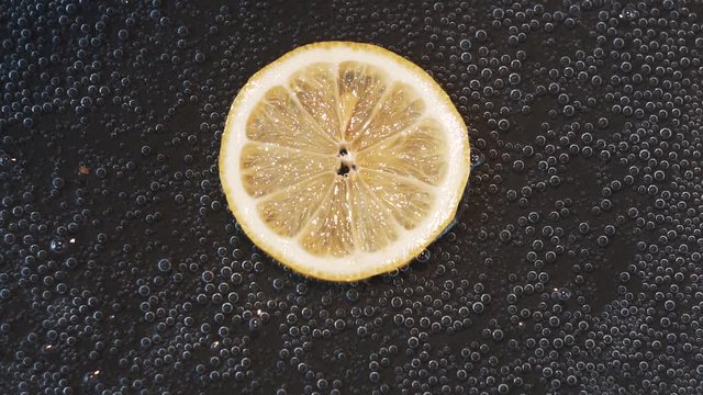 lemon slice on dark background close up