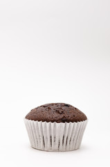 Chocolate cake in a paper cup on a white background