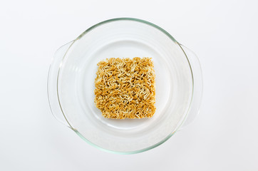 Clear bowl with instant noodle on a white backgroun