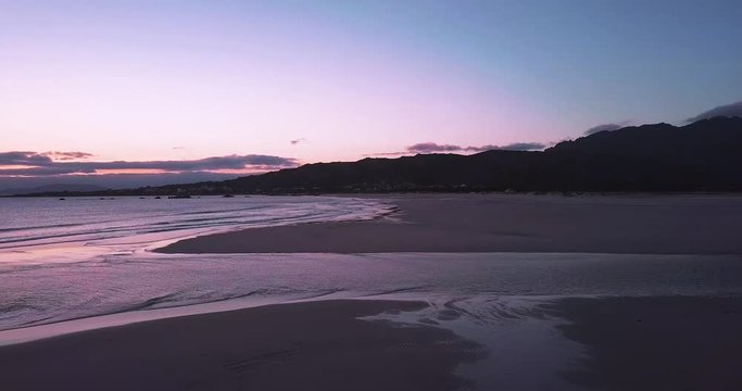 Sunset at a stunning Galician beach with a river estuary and a forest nearby n9