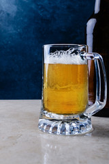 Glass of light beer  on marble table.