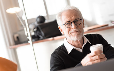 Senior businessman having a coffee break