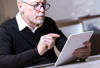 Senior man using his tablet