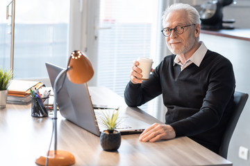 Senior businessman having a coffee break