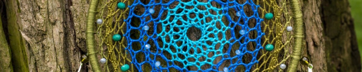 Banner of Handmade dream catcher with feathers threads and beads rope hanging