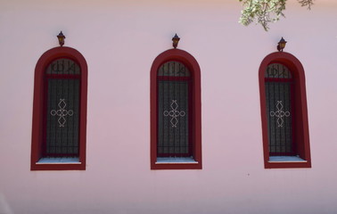 pink wall with windows from a Greek church