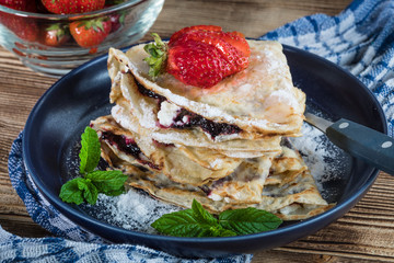 Polish pancakes with jam, cheese and strawberries.