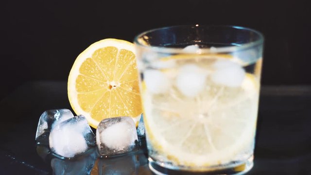 lemon on a dark background with pieces of ice