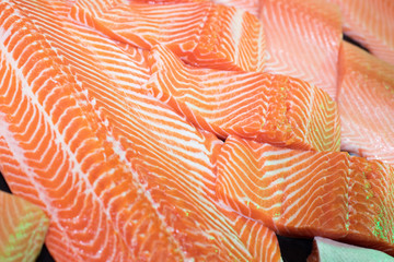 Salmon slice by fork knife with experience chef and arrange on fillet plate for roasted, sashimi,...