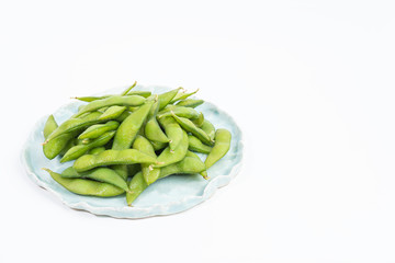 edamame beans in ceramic plate isolated on white background