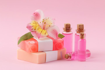 Spa. Aromatherapy. Body care cosmetics. Handmade soap and aroma oil on a gentle pink background