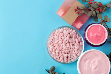 Spa. Aromatherapy. Body care cosmetics. Handmade soap and aroma oil and sea salt on a gentle light blue background. top view