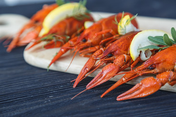 Close-up of boiled crawfish with lemon and herb