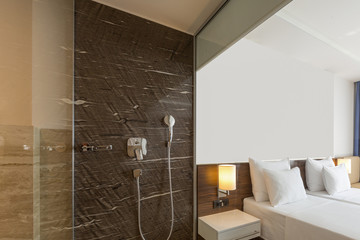 Interior of a luxury hotel room, bathroom and bedroom