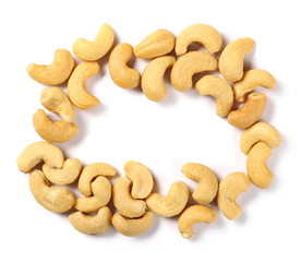 Salted cashew nuts frame and border isolated on white background, top view