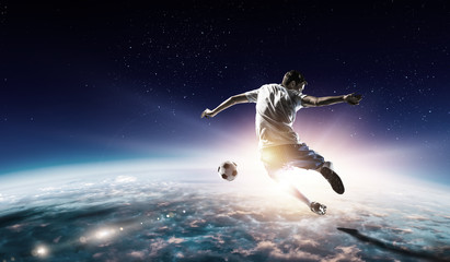 Obraz na płótnie Canvas Soccer player in outer space in action. Mixed media