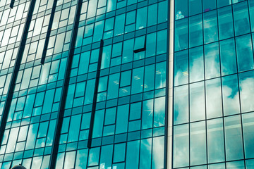 Obraz na płótnie Canvas Sky with clouds reflected in windows of modern office building.
