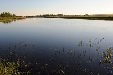 Fototapeta na wymiar autumn landscape with a lake on a flat terrain