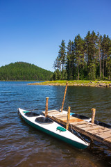 Fototapeta na wymiar lake, kayak, boat, pier, water, nature, summer, blue, travel, canoe, landscape, sky, mountain, green, tourism, tranquil, park, river, vacation, calm, national, red, outdoors, scenic, view, dock, fores