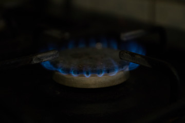 gas burner, blue flame on black background