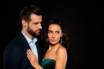 Close up side profile photo beautiful she her wife earrings he him his husband married spouse celebrities hands chest look listen empty space wear costume jacket green dress isolated black background