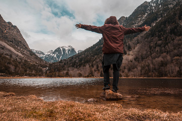 Young man in the Aigüestortes National Park in the Pyrenees, lifestyle photography