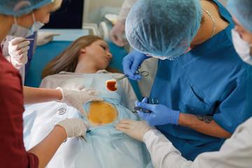 a group of surgeons doing operations in a hospital.