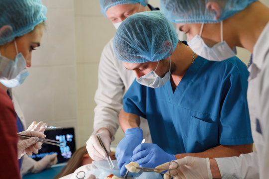 a group of surgeons doing operations in a hospital.