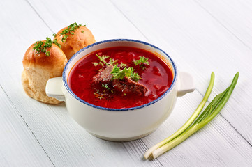 borsch with pampushkas, lard and onion at white table top. borsch is traditional ukrainian cuisine red soup with beet, potato, meat, carrot, cabbage and garlic. copy space